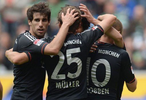 Bayern Munich&#039;s Arjen Robben, Javier Martinez and Thomas Mueller celebrate scoring in Moenchengladbach on May 18, 2013