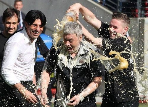 Frankfurt's players pour beer over head coach Armin Veh in Frankfurt, Germany, on May 18, 2013