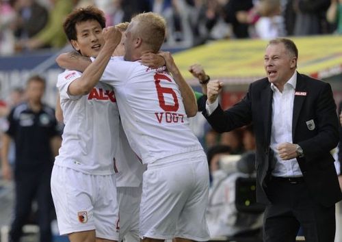 L-R: Augsburg's Dong-Won Ji,  Kevin Vogt and manager Stefan Reuter celebrate in Augsburg, on May 18, 2013