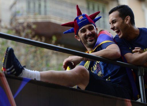 Barca&#039;s David Villa (L) and Pedro Rodriguez celebrate winning La Liga title, in Barcelona, on May 13, 2013