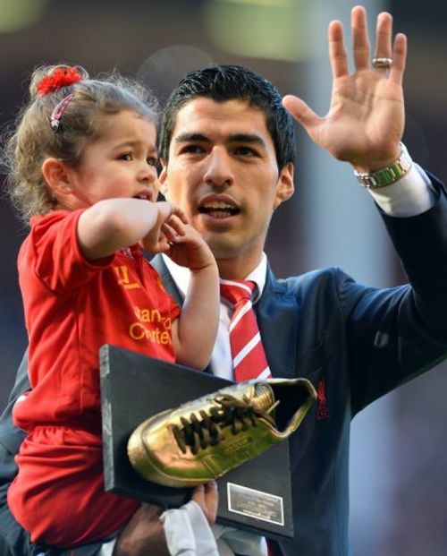 Liverpool's Luis Suarez with his daughter Delfina at the end of the Liverpool-QPR match on May 19, 2013