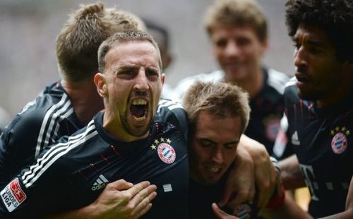 (L-R) Bayern Munich's Franck Ribery, Philipp Lahm and Dante celebrate during a Bundesliga match on May 18, 2013