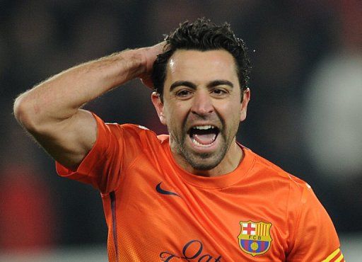 Xavi Hernandez celebrates after scoring in Paris on April 2, 2013