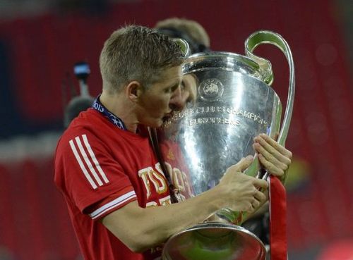 Bayern Munich's German midfielder Bastian Schweinsteiger kisses the trophy at Wembley Stadium in London on May 25, 2013