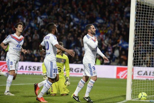 Lyon&#039;s Lisandro Lopez (R) is congratulated by teammates after scoring on May 26, 2013 at the Gerland stadium