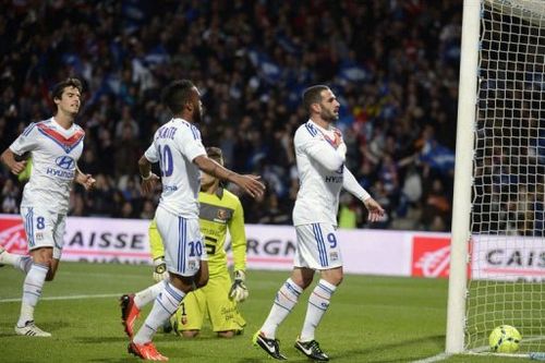 Lyon's Lisandro Lopez (R) is congratulated by teammates after scoring on May 26, 2013 at the Gerland stadium