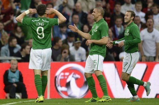 Republic of Ireland striker Shane Long (L) celebrates scoring at Wembley Stadium in north London on May 29, 2013