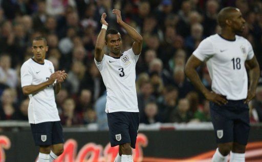 England defender Ashley Cole (C) applauds as he is substituted in north London on May 29, 2013