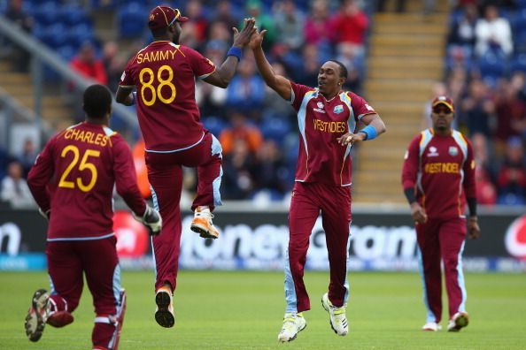 Dwayne Bravo(2R) of West Indies high fives Darren Sammy (2L) after capturing the wicket of JP Duminy of South Africa during the ICC Champions Trophy Group B match between West Indies and South Africa at the SWALEC Stadium on June 14, 2013 in Cardiff, Wales.  (Getty Images)