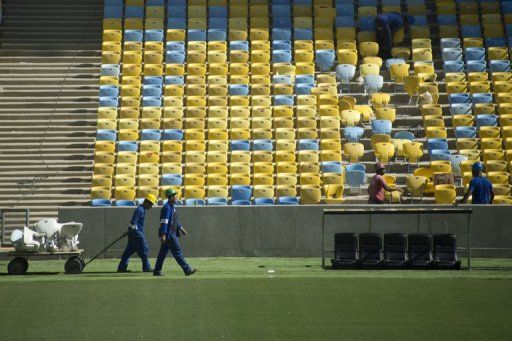 Workers carry chairs at the Maracana stadium in Rio de Janeiro, on May 15, 2013