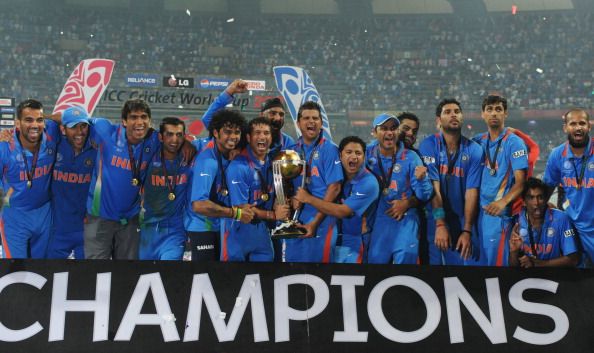 Indian cricketers pose with the trophy a