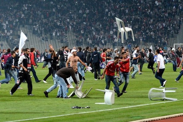 Besiktas football team supporters clash with riot police and security forces during the Turkish Super League soccer match between Besiktas and Galatasaray at the Ataturk Olympic Stadium