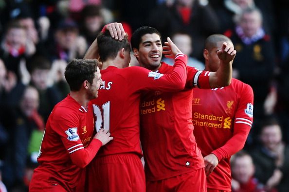 LIVERPOOL, ENGLAND - DECEMBER 21:  Luis Suarez (2nd right) of Liverpool celebrates with team mates after scoring during the Barclays Premier League match between Liverpool and Cardiff City at Anfield on December 21, 2013 in Liverpool, England.  (Photo by Clive Brunskill/Getty Images)