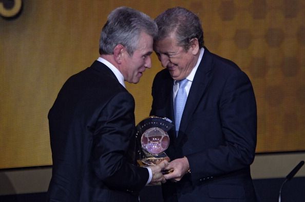 Bayern Munich's former German coach Jupp Heynckes (L) receives the 2013 FIFA Coach of the Year award from England manager Roy Hodgson