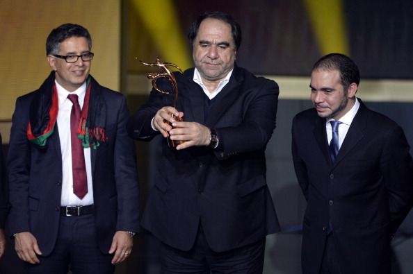 Afghanistan Football Federation president Karim Keramuddin (C) receives the 2013 FIFA Fair Play award