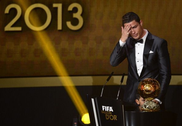 Real Madrid's Portuguese forward Cristiano Ronaldo receives the 2013 FIFA Ballon d'Or award for player of the year