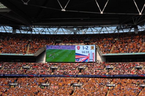 Fans applaud during the 56th minute of the match in memory of the 56 people who lost their lives in the Bradford City stadium fire during the FA Cup with Budweiser Final match between Arsenal and Hull City at Wembley Stadium on May 17, 2014