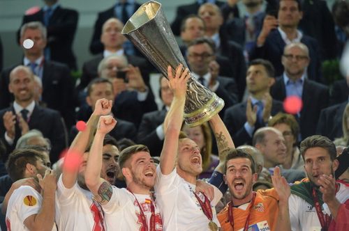 Sevilla players celebrate with the trophy