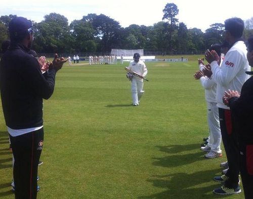 Khurram Khan receives a guard of honour from teammates after his final international innings against Ireland