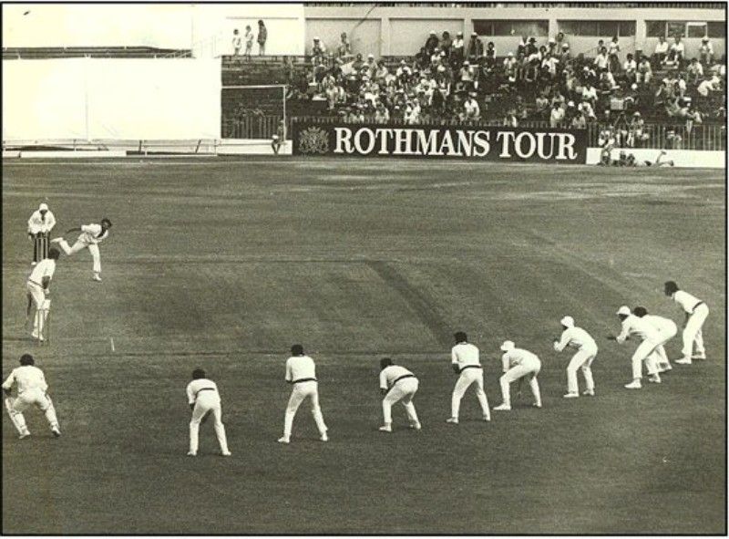 Dennis Lillee bowling with 9 slips