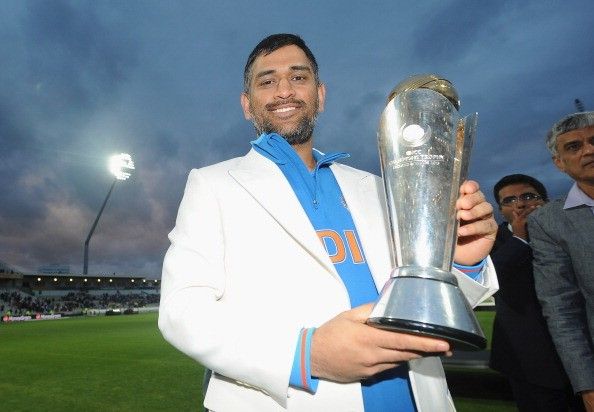 Dhoni with the 2013 Champions Trophy after leading his side to an improbable victory