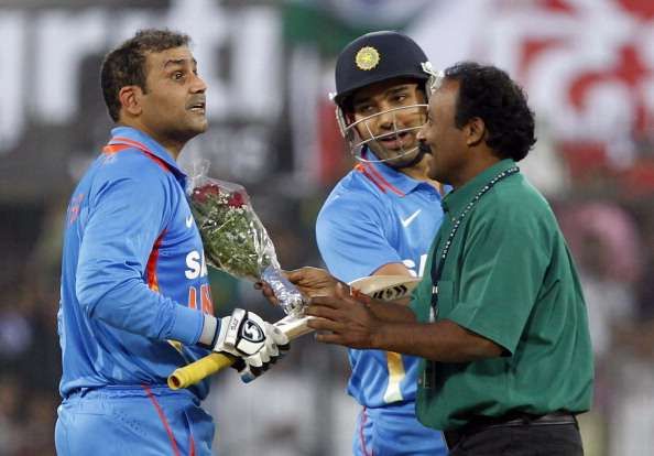 Virender Sehwag of India is congratulated with flowers by a fan after scoring a double century in 2011 in Indore