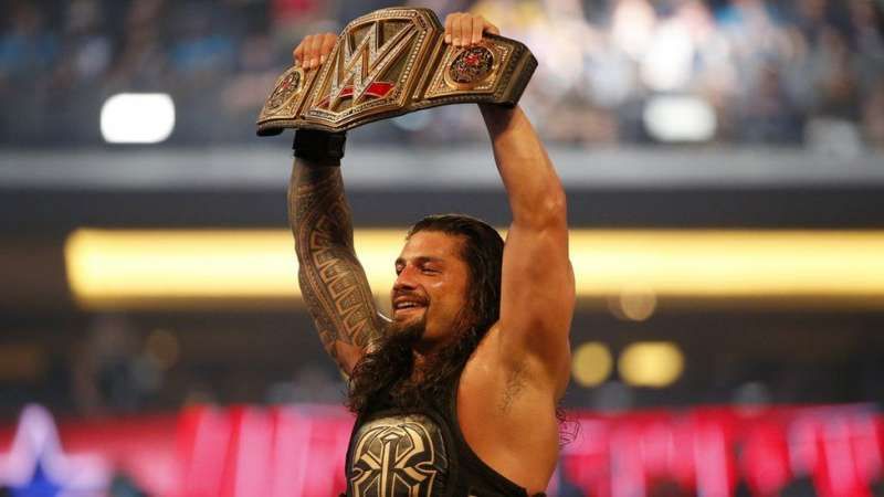 Roman Reigns with the heavyweight championship