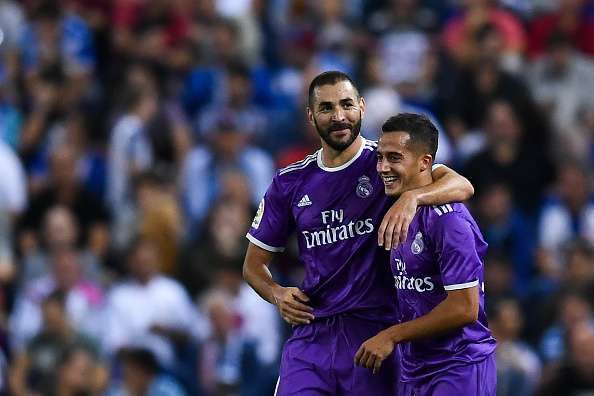 BARCELONA, SPAIN - SEPTEMBER 18:  Karim Benzema (L) celebrates with his team mate Lucas Vazquez of Real Madrid CF after scoring his team's second goal during the La Liga match between RCD Espanyol and Real Madrid CF at the RCDE stadium on September 18, 2016 in Barcelona, Spain.  (Photo by David Ramos/Getty Images)