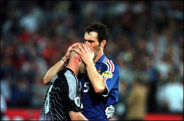 Blanc kissing the head of Barthez before a game